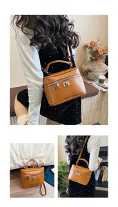 Detailed views of a brown box-shaped handbag with silver lock and top handle