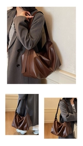Detail of adjustable wide shoulder strap on brown matte leather hobo tote bag