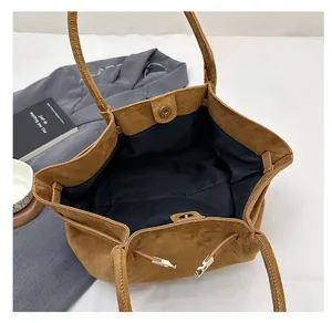 Top view of large brown suede tote bag showing magnetic closure and spacious interior