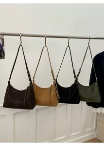 Close-up of hobo shoulder bags in brown, yellow, black and green with adjustable straps