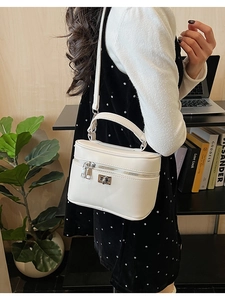 Modern white PU leather box bag styled on a person in a minimalist interior setting