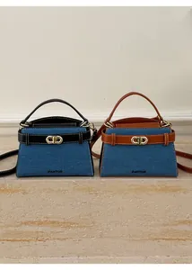 Detail of mini denim Boston bags with leather trim and gold metal CD buckle detail