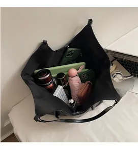 Internal view of a black tote bag showing high capacity for tablets and daily items