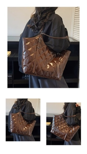 Detail view of large quilted tote bag with glossy mirror finish and adjustable straps