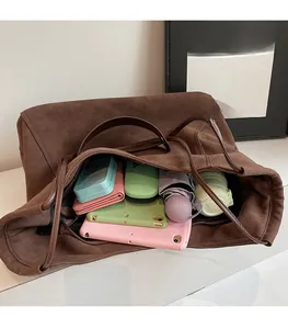 Deep brown suede tote bag showing large interior capacity for daily essentials and gadgets