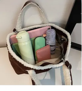 Top view of spacious interior of brown plush tote bag showing items for daily use