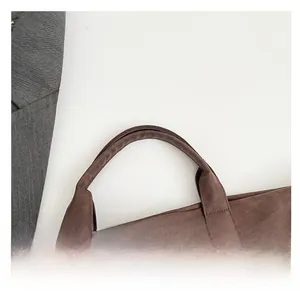 Detail of coffee brown tote bag showing reinforced handles and fine stitching quality