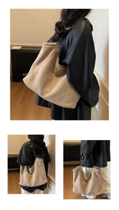 Detail view of large beige suede tote bag featuring slim brown leather shoulder straps