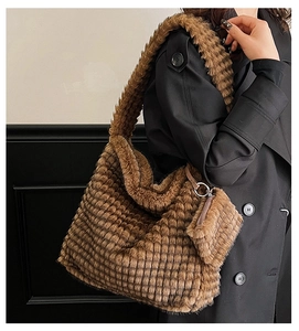 Detail of soft brown plush tote bag with checkered texture and mini coin purse hanging