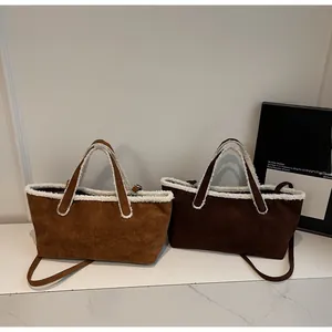Detail of suede tote bags with white faux shearling trim in brown and coffee colors