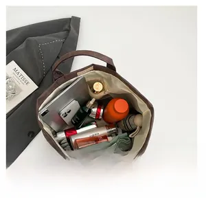 Detailed interior view showing large capacity and compartments of the brown tote bag