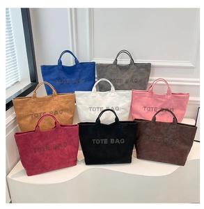 Detailed close-up showing eight colorful suede tote bags with rivet studded TOTE BAG text