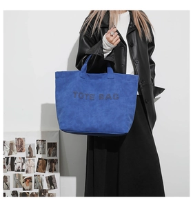 Blue suede tote bag with rhinestone TOTE BAG text shown on a fashion model