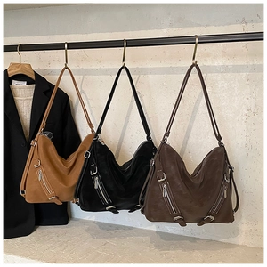 Detailed view of large vintage hobo bags in brown and black with matte leather texture