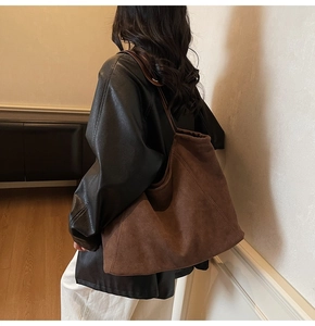 Suede zipper tote bag shown on shoulder in daily commute scene for winter style