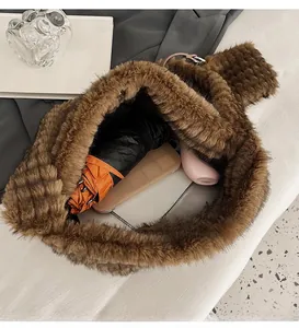 Top view of spacious brown plush tote bag interior with multiple everyday items