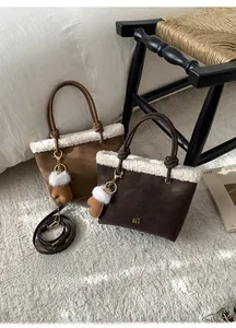 Detail of suede bucket bags with faux shearling trim and decorative knotted handles