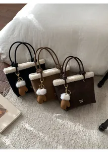 Three corduroy tote bags with white faux fur trim and cute glove charms on a plush rug