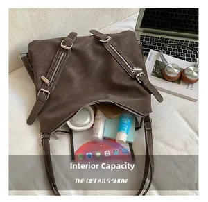 Detail of large capacity dark brown tote bag with multi-zipper pockets and daily essentials