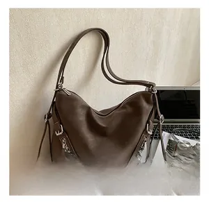 Retro brown suede tote bag styled with a laptop and headphones for daily commute