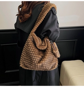Detail of dark brown plush cloud bag with grid texture and matching detachable pouch