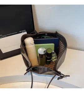 Detailed interior of vintage brown tote bag showing large capacity with drawstring closure
