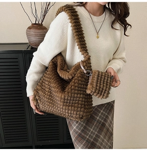 Close-up of soft plush brown tote bag with quilted texture and small matching pouch