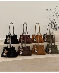 Detailed display of vintage large tote bags in black, dark brown, caramel, and olive green