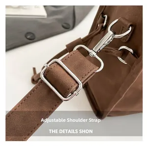 Macro shot of adjustable shoulder strap with silver buckle on brown vintage pillow bag