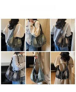 Detail view of large denim tote bag showing metal rivets and functional zipper pockets