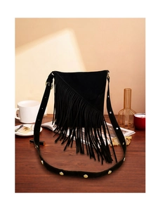Detail of black suede fringe bag featuring wide strap with gold metallic studs decoration