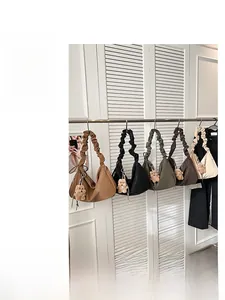 Detailed display of pleated hobo bags in five colors with cute plush bear charms