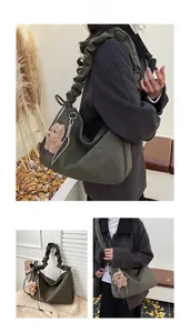 Detail of dark olive green pleated shoulder bag with cute teddy bear plush charm