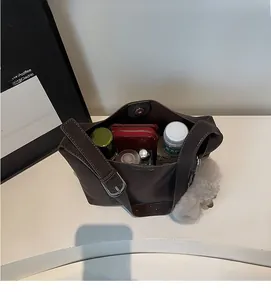Detailed interior of the brown suede dumpling bag showing its large storage capacity