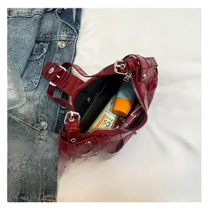 Detail view of burgundy crocodile pattern crescent bag showing interior storage capacity