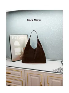 Detailed back view of a dark brown suede tote bag featuring geometric embossed texture