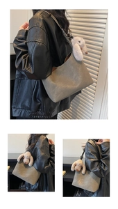 Detail of grey suede tote bag featuring a cute plush bunny charm and spacious minimalist design