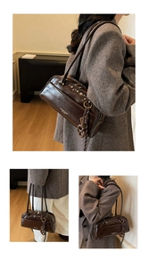 Detail of dark brown glossy leather shoulder bag with side charm shown in various angles