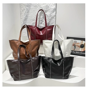 Detailed display of five color options for large tote bags with silver rivet accents