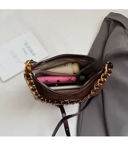 Detail view of the spacious inner compartment of the brown patchwork shell bag