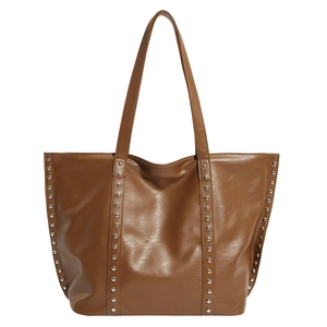 Retro brown large-capacity leather tote bag with silver metal studs on white background