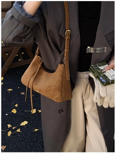 Chic caramel leather underarm bag with grainy texture and adjustable shoulder strap