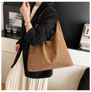 Brown matte tote bag shown in a lifestyle office setting for daily commute look