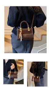 Detail view of brown textured leopard style handbag with woven handle and beaded tassel