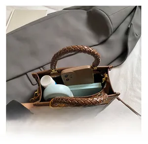 Top view of compact crossbody bag interior showing storage for phone and cosmetics