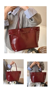 Macro view of burgundy patent leather tote bag featuring stylish silver stud accents