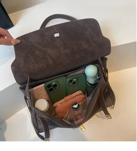 Detail shot of the large capacity dark brown tote bag showing organized interior storage