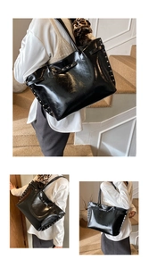 Detail showing high-gloss black tote bag with silver studs and decorative buckle