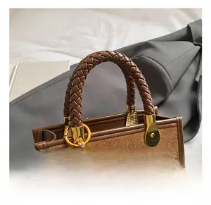 Detail of brown faux leather bag with woven handle, gold hardware and colorful beads