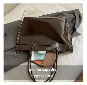 Macro view of large tote bag interior showing spacious storage for books and cosmetics